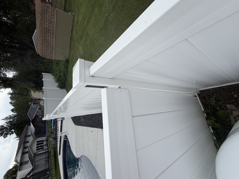 A post to rail junction at the pool enclosure showing separation and gapping.