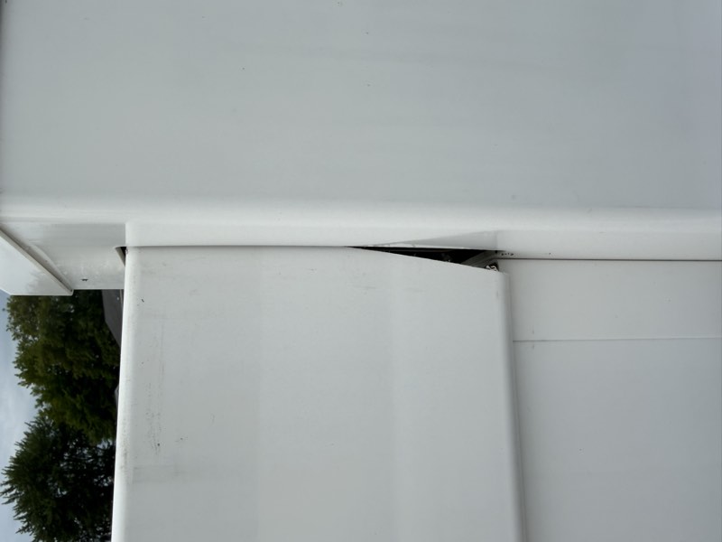 A horizontal rail pulled free from its post socket leaving an open gap with daylight visible.