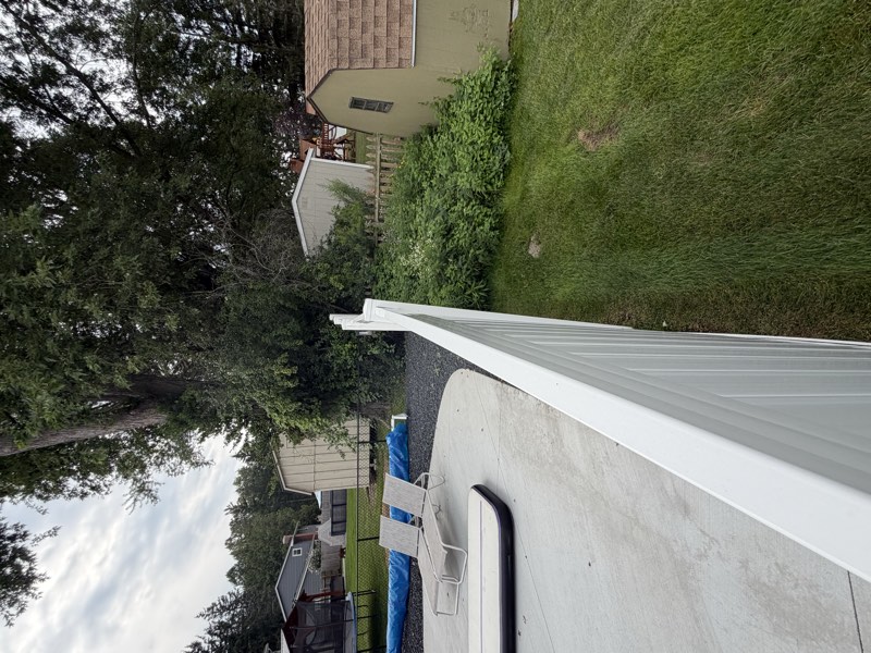 A fence top rail bowing and waving along a long straight run instead of sitting level.